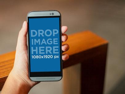 Mockup of a Young Woman Holding an HTC One M8