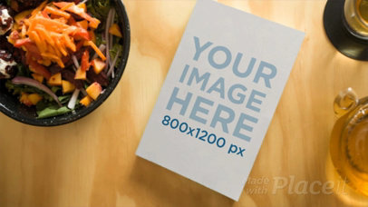 Book Video Lying on a Wooden Table with Healthy Food Surrounding It