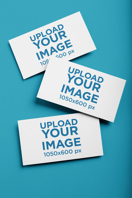Mockup of Three Business Cards on a Solid Color Surface