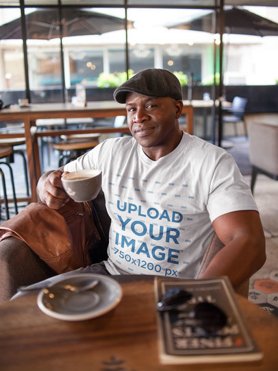 T-Shirt Mockup Featuring a Man Wearing a Beret Sitting Casually