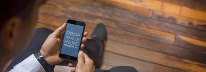 Black iPhone 6 Mockup Template Featuring a Young Executive