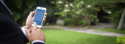 White iPhone 6 Mockup Featuring a Businessman at The Garden