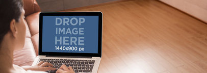 Laptop Mockup of a Woman Using a Macbook Pro on a Sofa