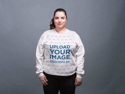 Mockup of a Plus Size Crewneck Sweatshirt Featuring a Woman with a Ponytail Against a Gray Background