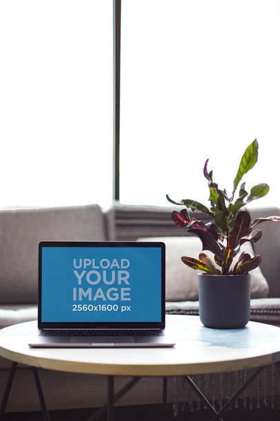 MacBook Mockup on a Coffee Table Next to a Plant Pot 21615