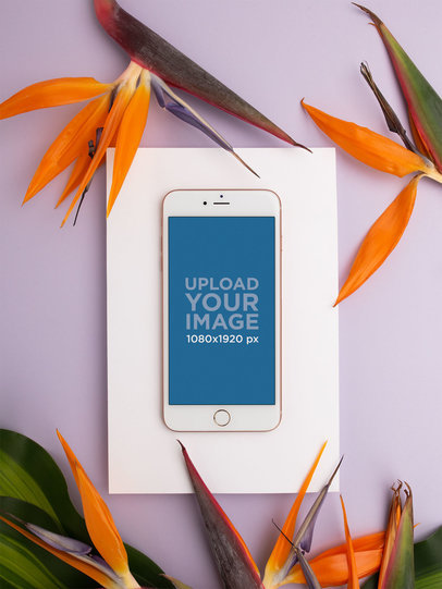 iPhone Mockup Lying Near Birds of Paradise Flowers