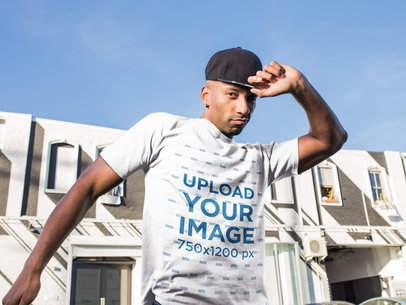 Mockup of a Man Wearing a T-Shirt and a Snapback Hat