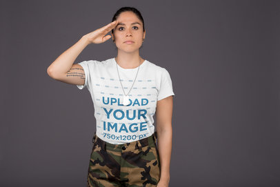 Round Neck Tee Mockup Featuring a Veteran Woman Saluting Against a Gray Background