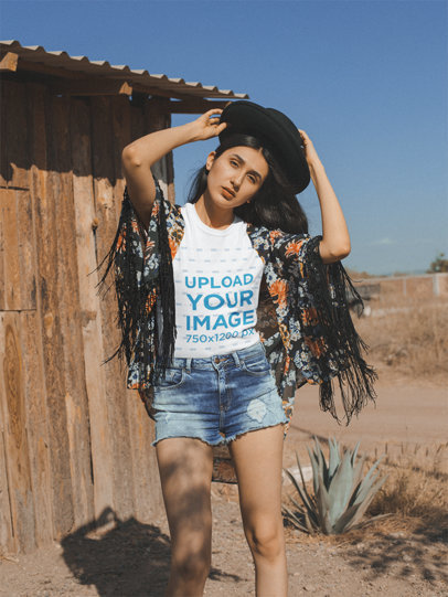 Mockup of a Hipster Woman Wearing a T-Shirt in a Sunny Desert Cabin Area