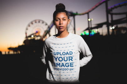 Crewneck Sweatshirt Mockup Featuring a Girl with a Bun Posing at a Fair at Night 18331