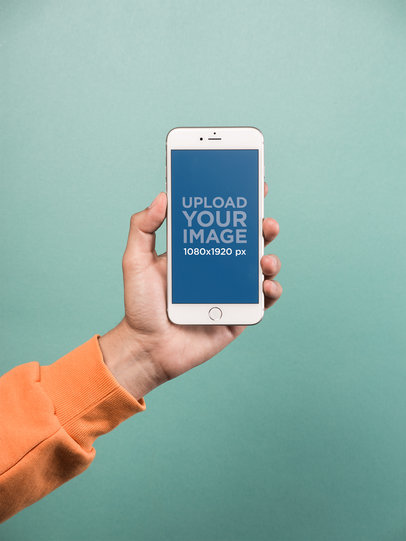 Mockup of a Hand Holding a Silver iPhone 8 Plus over a Solid Teal Background