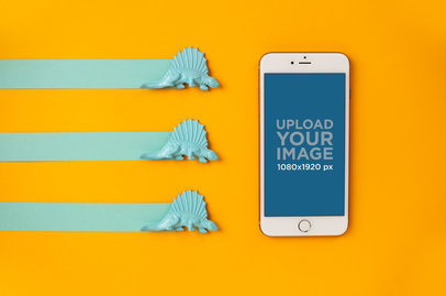 iPhone 8 Mockup over a Yellow Background Next to Toy Dinosaurs 21636