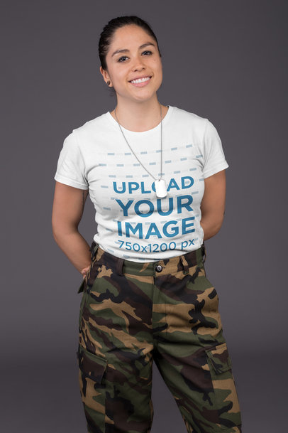 T-Shirt Mockup of a Female Veteran Against a Gray Wall