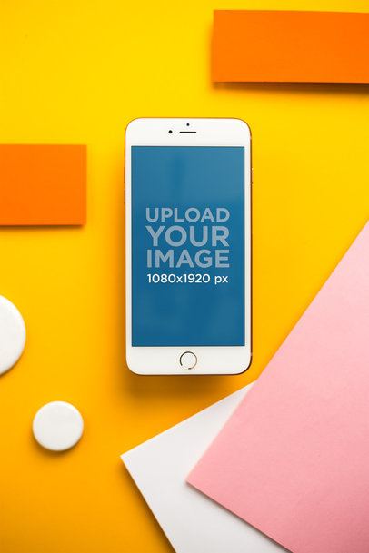 Mockup of a Gold iPhone 8 Plus over an Orange Background with Colorful Shapes