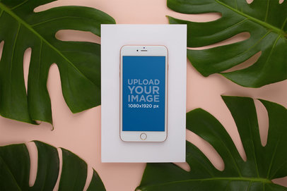 Mockup of a Rose Gold iPhone 8 Surrounded by Leaves