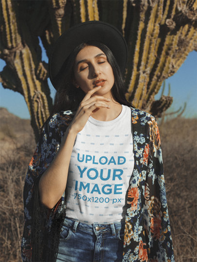 Camping T-Shirt Mockup Featuring a Hipster Woman Posing Against a Cactus Plant