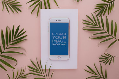 Mockup of a Gold iPhone 8 Plus Surrounded by Leaves