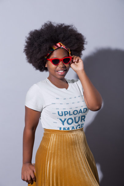 T-Shirt Mockup Featuring a Woman Wearing a Gold Pleated Skirt