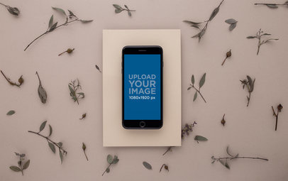 Space Gray iPhone 8 Plus Mockup Surrounded by Dry Thin Leaves