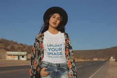 Mockup of a Woman Wearing a T-Shirt Standing by an Empty Road