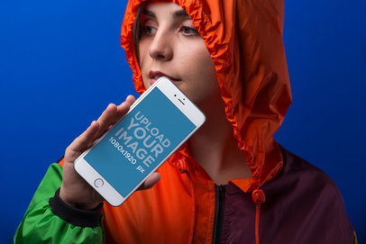 iPhone 8 Plus Mockup Featuring a Young Woman Posing Against a Blue Background