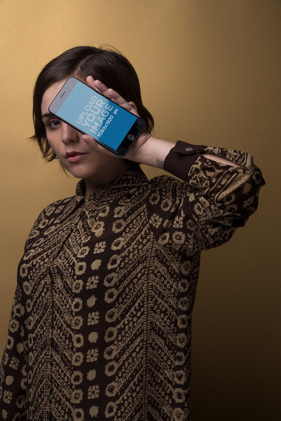 Space Grey iPhone 8 Plus Mockup Held by a Woman in a Studio