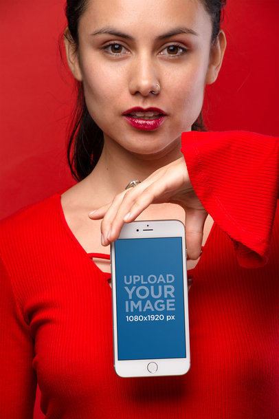 Mockup of a Woman Holding a Silver iPhone 8 Wearing All Red