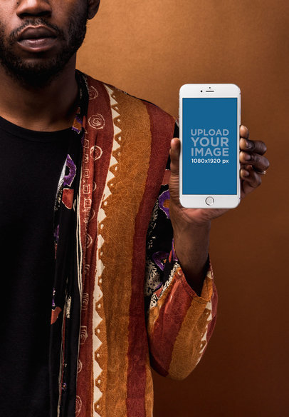 Mockup of a Silver iPhone Held by a Serious Man