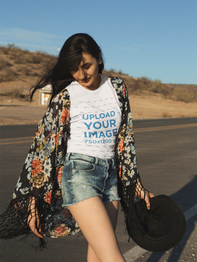 T-Shirt Mockup with a Woman Looking Down and Wind Blowing Her Hair 18888