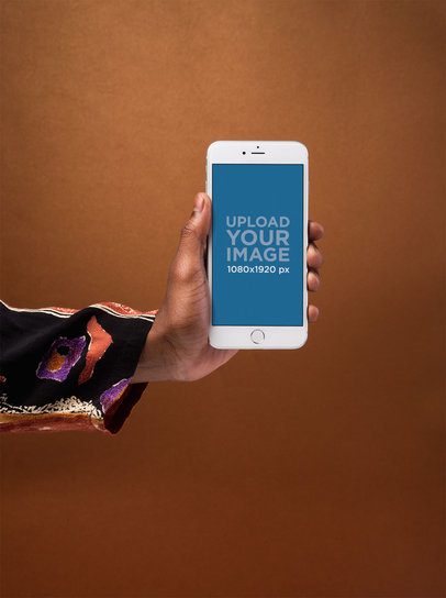 iPhone 8 Plus Mockup Held by an Arm Wearing a Patterned Sleeve