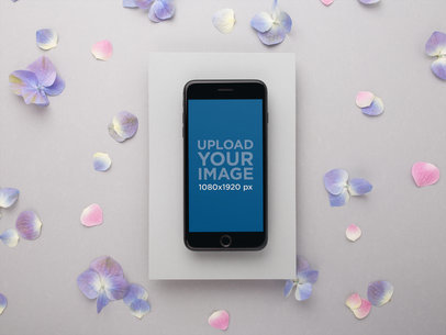 Mockup of a Space Grey iPhone Surrounded by Hydrangeas 21979