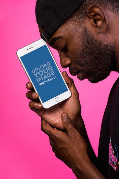 iPhone 8 Plus Mockup Featuring a Man Wearing a Hat Backwards and Leaning His Forehead into the iPhone 22083