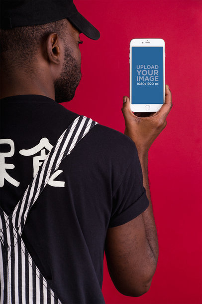 Mockup of an iPhone 8 Plus In Front of a Red Background