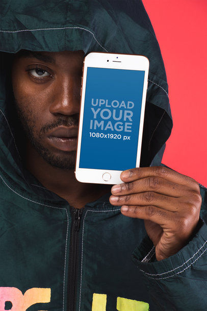 Mockup Featuring a Serious-Looking Man Holding a Gold iPhone 8 Plus in Front of His Face