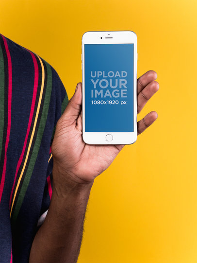 Mockup of a Silver iPhone 8 Plus Held by a Man Wearing a Striped Shirt