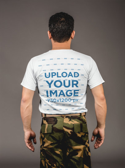 Backshot Tshirt Mockup of a Middle-Aged Soldier Standing Against a Gray Wall