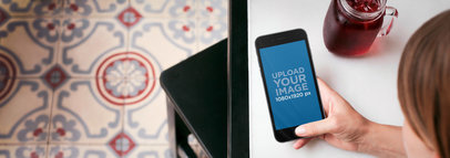 Mockup Template of a Woman Using iPhone 6 While Having a Drink