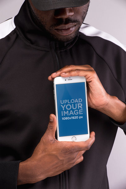 iPhone 8 Plus Mockup Held by a Man With Both Hands