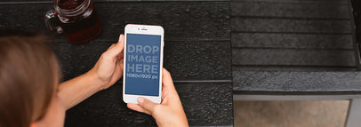 White iPhone 6 Mockup of a Woman at a Café