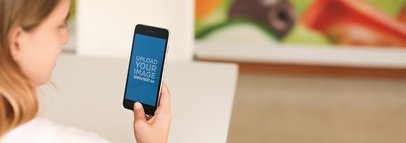 Mockup of a Woman Using iPhone 6 at an Art Gallery