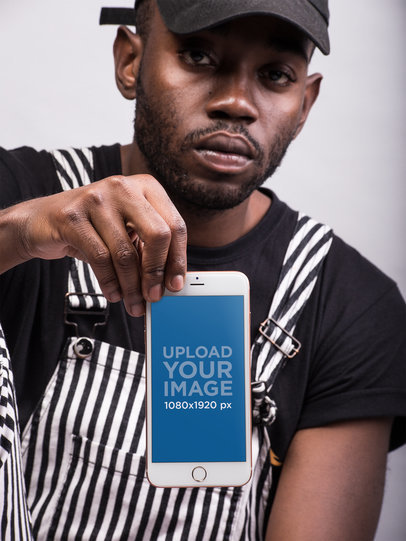 Gold iPhone Mockup Featuring a Serious-Looking Young Man Wearing Black and White 22087