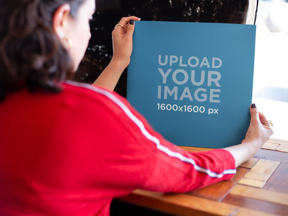 Mockup of a Woman Holding a Vinyl Cover