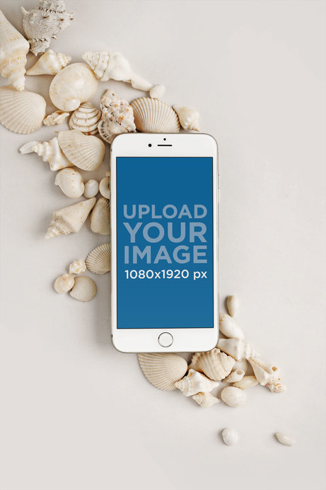 Mockup of an iPhone Lying Over Small Seashells