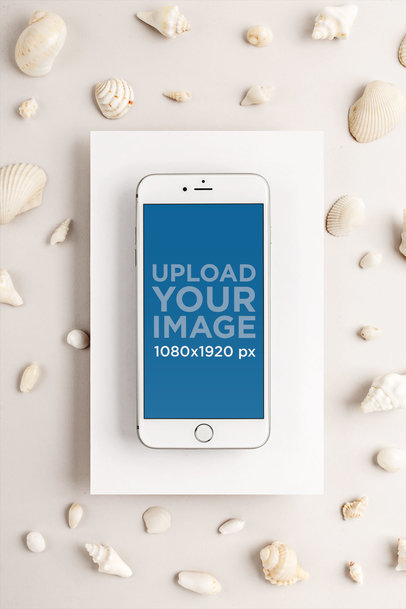 Silver iPhone 8 Plus Mockup on a Cardboard Surrounded by Seashells