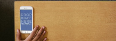 White iPhone 6 Lying on Coffee Table Mockup Template