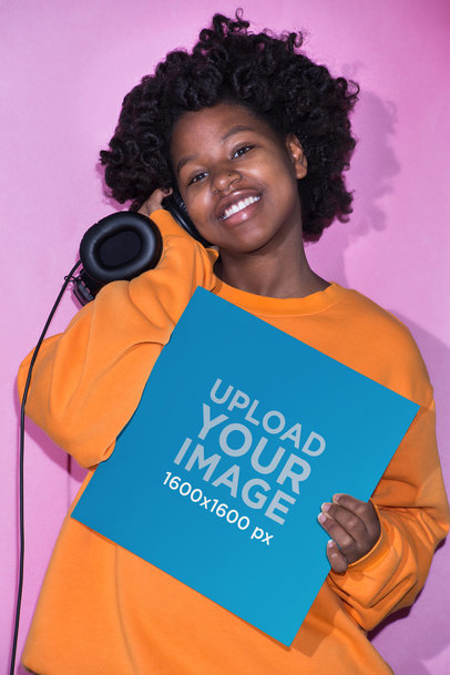 Mockup Featuring a Smiling Girl with Headphones Showing a Vinyl Record Cover Against a Pink Background 22114