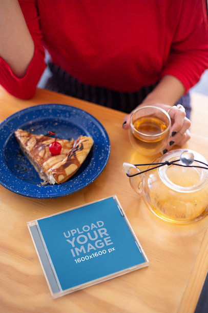 CD Cover Mockup Featuring a Woman Drinking Tea at a Restaurant 