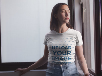  T-Shirt Mockup of a Woman Looking Out a Window