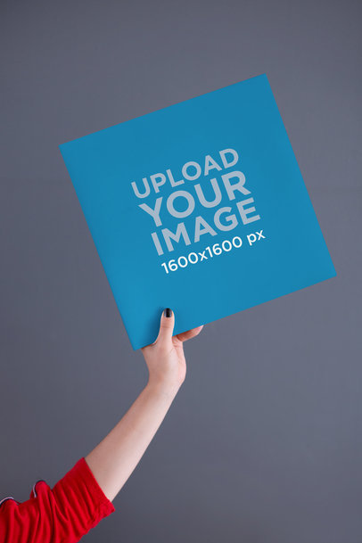 Vinyl Mockup Held Over a Gray Background 