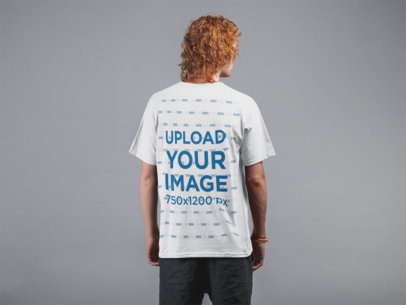 Backshot Mockup of a Man with Red Hair Wearing a T-Shirt Against a Flat Wall 